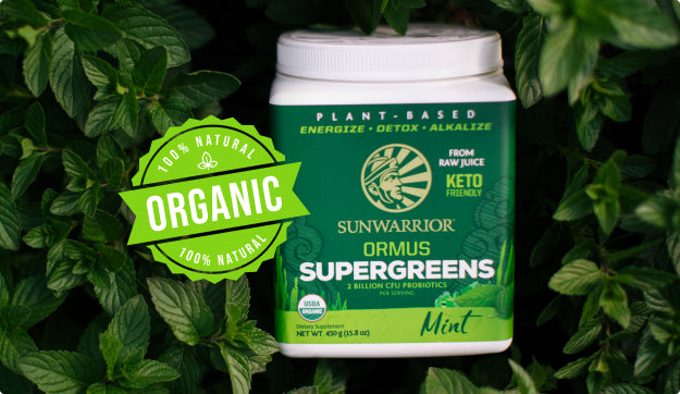 Sunwarrior Ormus Supergreens container surrounded by fresh mint leaves and organic label icon