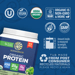 Container of plant-based organic protein powder with certification and recycling icons on blue background