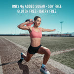 Woman in sportswear lunging on outdoor track with text about low sugar and free-from ingredients