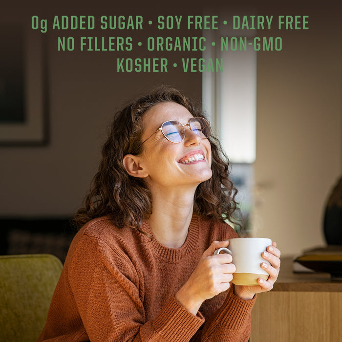Smiling woman in glasses wearing a brown sweater holding a white mug indoors with wellness benefits text above.