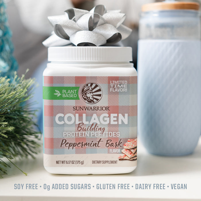 Container of Sunwarrior plant-based collagen protein peptides in peppermint bark flavor with a silver gift bow on top