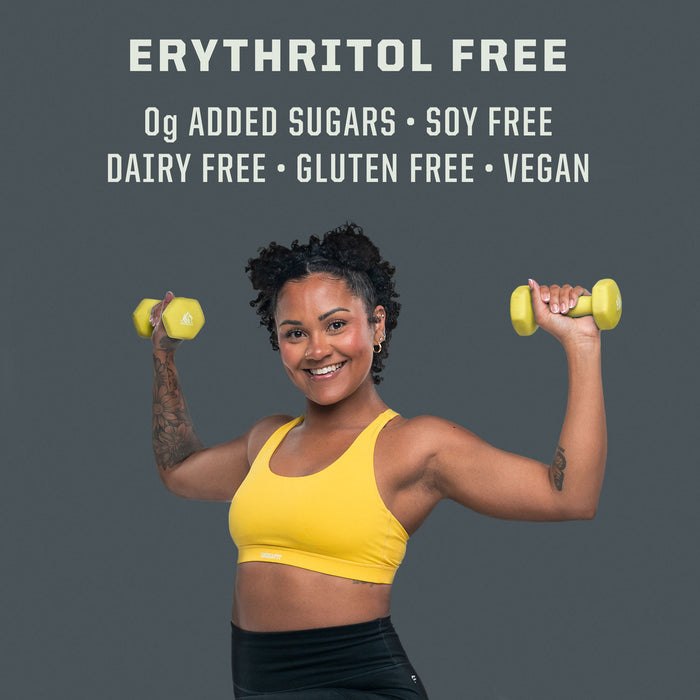 Woman in yellow sports bra lifting yellow dumbbells with text highlighting erythritol free, 0g added sugars, soy free, dairy free, gluten free, and vegan.