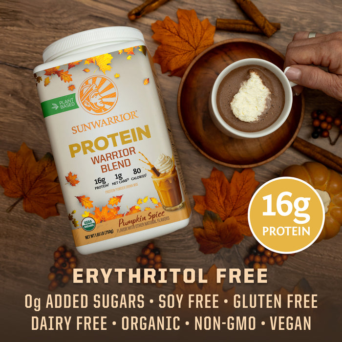Container of Sunwarrior plant-based Pumpkin Spice protein powder with cup of spiced drink and autumn leaves.