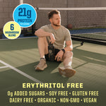 Man sitting on tennis court holding bottle with text highlighting protein and mushroom blend, free from sugar and allergens