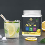 Sunwarrior Active Creatine container beside lemonade drink with lemon slice and mint leaves.