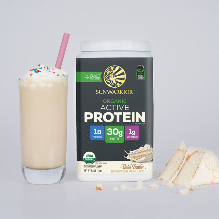 Container of Sunwarrior organic active protein powder beside a vanilla milkshake with sprinkles and cake slices