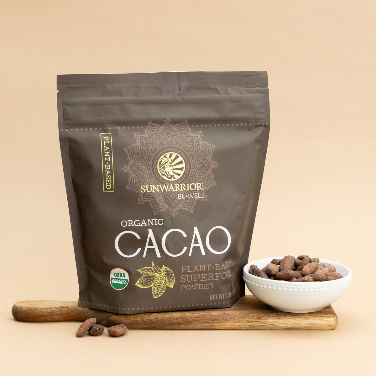 Sunwarrior Organic Cacao package on a beige background with a bowl of cacao beans.