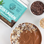 Sunwarrior collagen powder container, chocolate smoothie bowl with oats and cacao nibs on white table