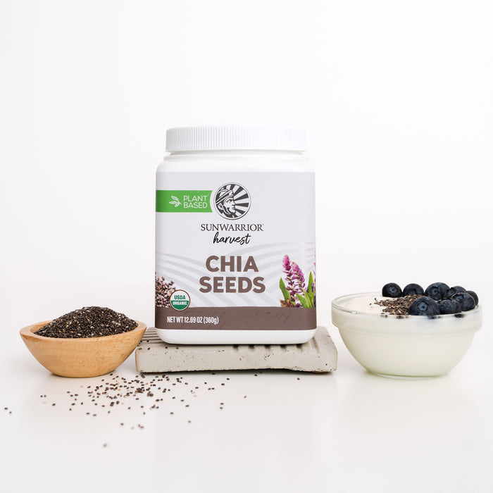 Container of plant-based chia seeds with a bowl of chia seeds and yogurt topped with blueberries