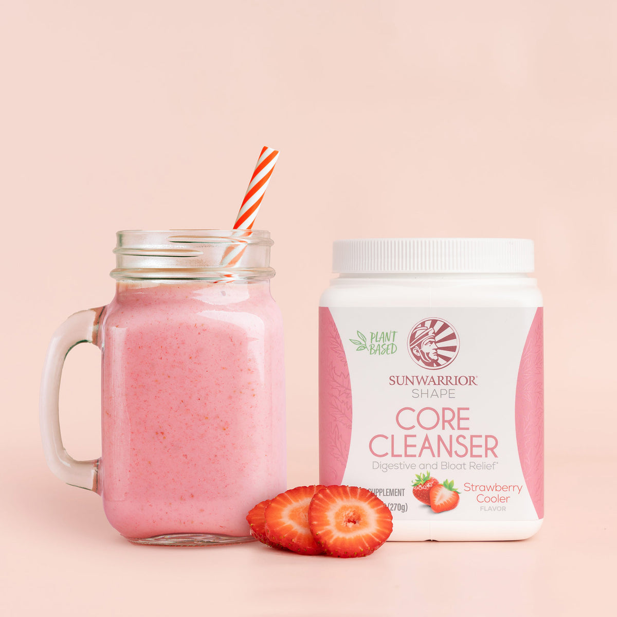 Jar of pink strawberry smoothie with a plant-based cleanser tub and sliced strawberries on a pale background