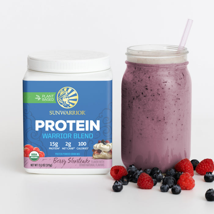 Sunwarrior Warrior Blend berry shortcake plant-based protein powder with a purple smoothie and berries