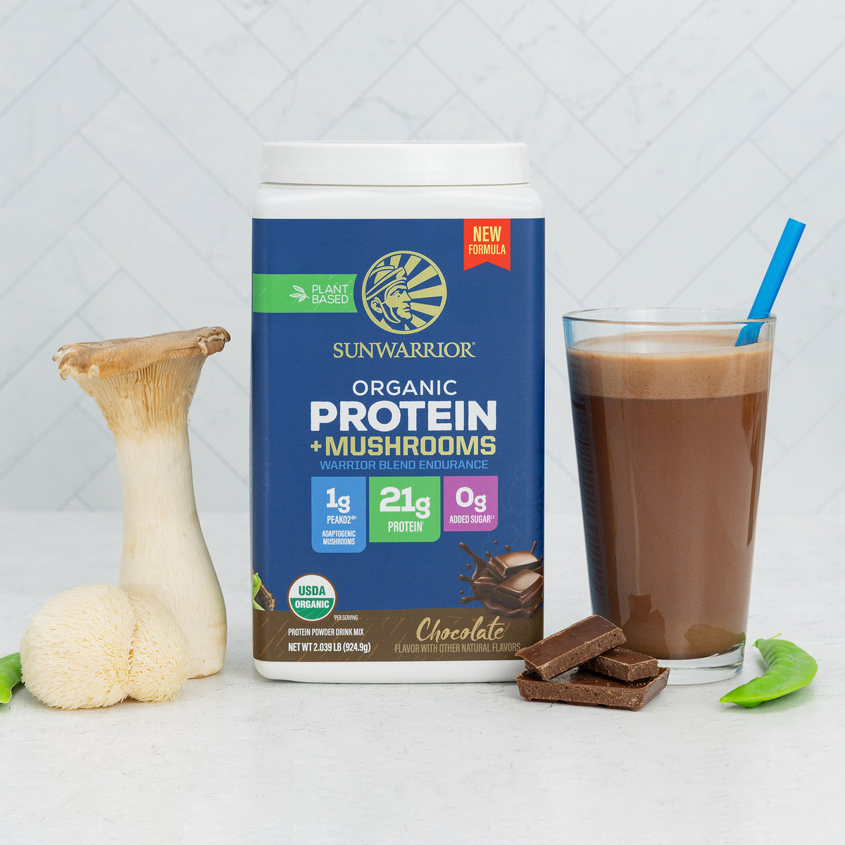 Container of plant-based chocolate protein powder with mushrooms next to a smoothie and fresh mushrooms