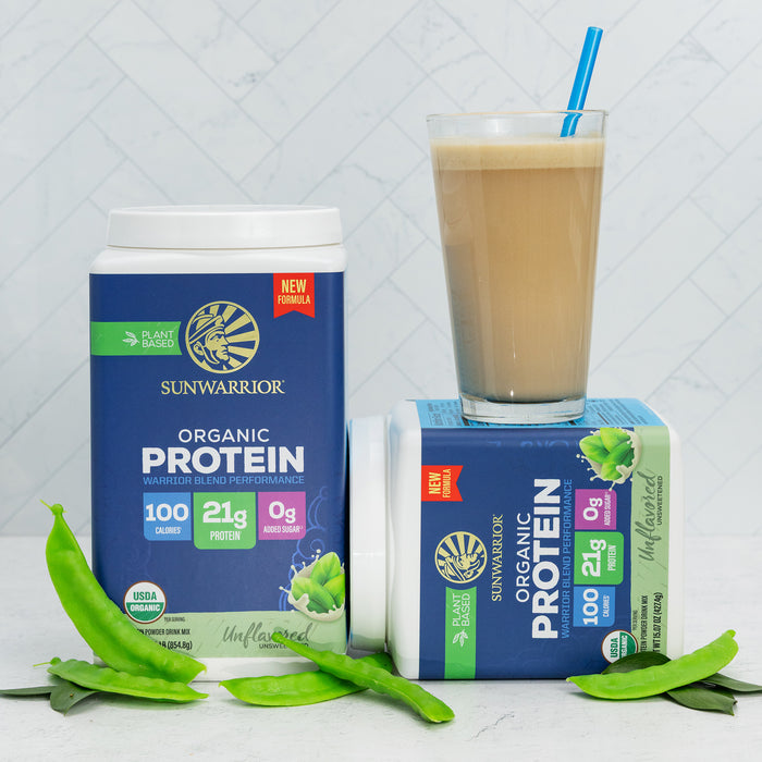 Two containers of Sunwarrior organic plant-based protein powder with a glass of protein shake and green pea pods.