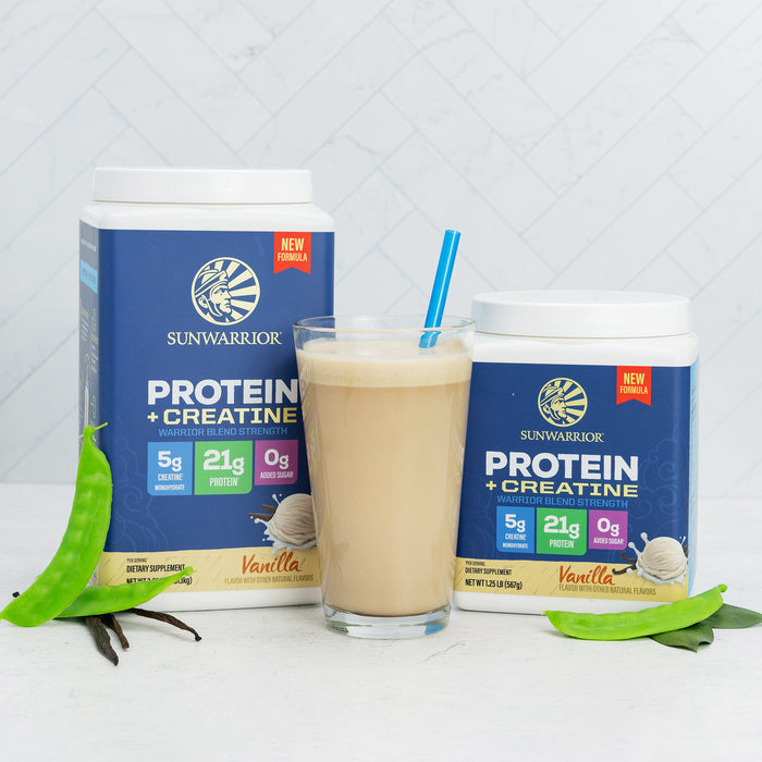 Sunwarrior vanilla protein and creatine powder containers with a smoothie in a glass and green leaves nearby