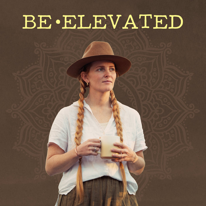 Woman holding a mug with 'BE•ELEVATED' text above on a patterned background