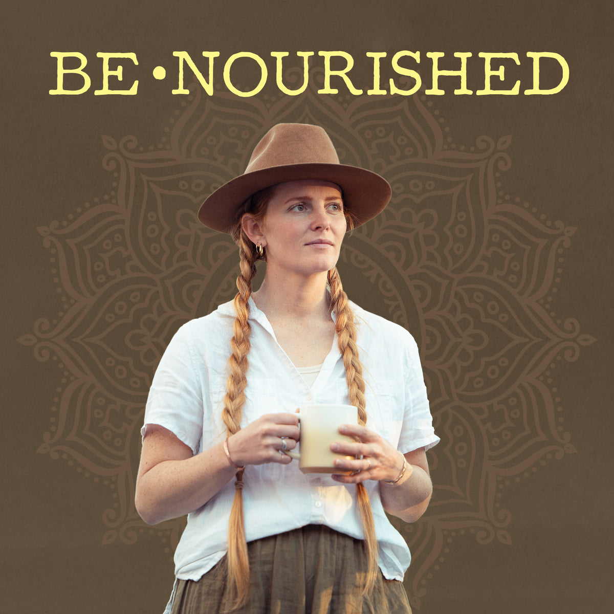 Woman with long braids and hat holding a creamy beverage with 