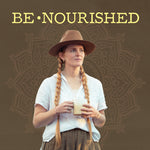 Woman with long braids and hat holding a creamy beverage with 