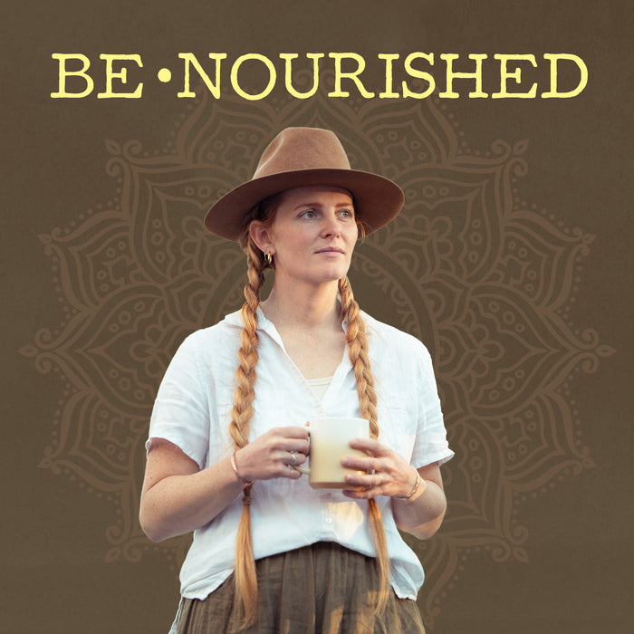 Woman with long braids and hat holding a creamy beverage with 
