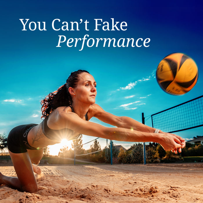 Woman diving to hit a volleyball on sand court at sunset with text about real performance
