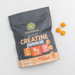 Sunwarrior creatine gummies package with three round peach-colored gummies on white background