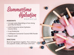 Popsicles on a plate with blueberries and a recipe card for a coconut berry hydration popsicle.