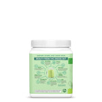 Container with green label detailing ingredients and benefits of a plant-based wellness powder blend
